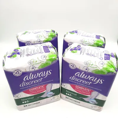 Four packages of Always Discreet sanitary pads are arranged on a white background.