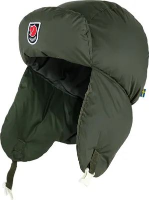 A green trapper hat with ear flaps and a logo on the side.