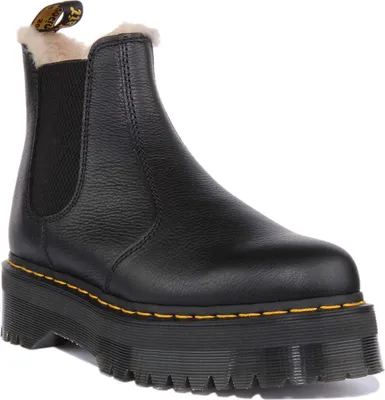 A black leather boot with a thick platform sole and faux fur lining.