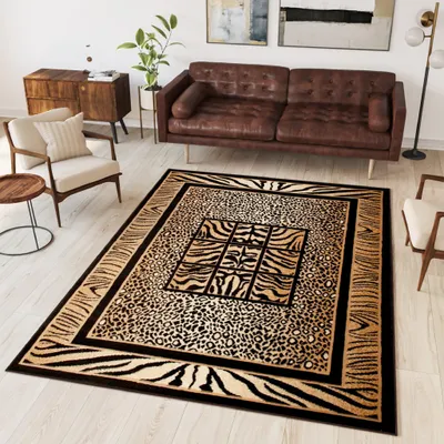 A living room scene with a sofa, armchair, side table, and a rug with animal print patterns.