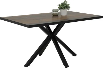 A rectangular dining table with a dark wood-effect top and a black metal star-shaped base, shown on a white background. A small potted plant and a jar of items are placed on the table.