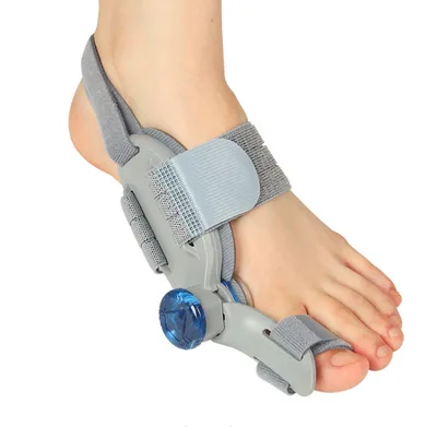 Close-up of a foot wearing a bunion corrector device against a white background.