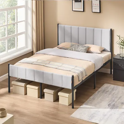 A bedroom scene with a bed and bedding.