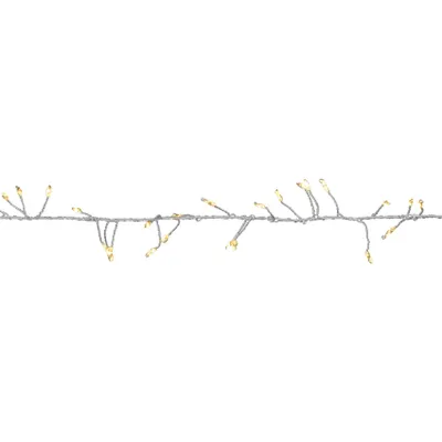 A string of LED lights on a silver wire against a white background.