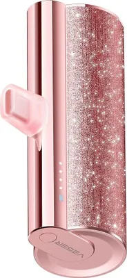 A rose gold power bank with glitter accents and a built-in Lightning plug.