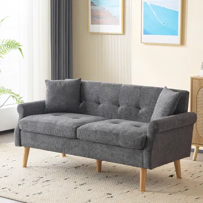 A gray sofa with wooden legs is shown in a living room setting.