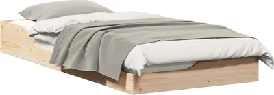 A low-angle shot of a wooden bed frame with bedding.