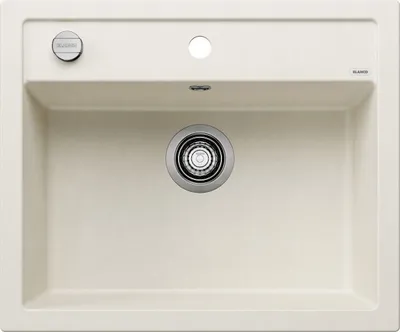 A top-down view of a cream-colored kitchen sink with a drain and faucet holes.