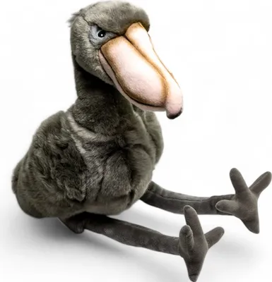 A plush toy of a shoebill bird sitting on a white background.
