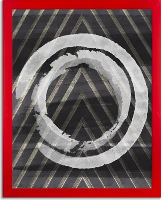 A framed picture with a red border, featuring concentric white circles on a dark background with diagonal gold lines.
