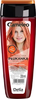 A bottle of hair conditioner with a picture of a woman with orange hair on the label.