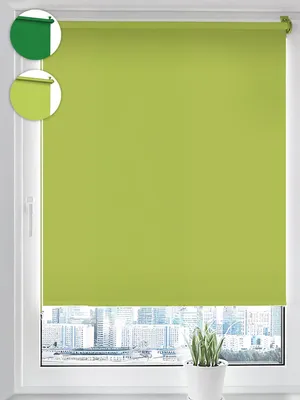 A roller blind in lime green is shown hanging in a window, with a cityscape visible through the lower part of the window.