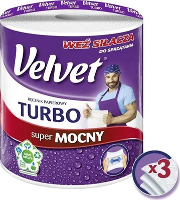 A roll of Velvet Turbo paper towels with a man demonstrating its strength.