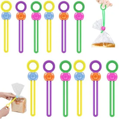 Produktbild von 12 Stück Frischhalteklammern - Verschlussklemmen - Beutelclips - Beutelverschlüsse - Verschlussclips - Verschlussklemmen - Chipsklemmen - Beutelklemmen - Lebensmittelklemmen - Frischhalteklammern - Beutelklemmen/ -klammern - Wiederverwendbar - Silikon - Beutelclips für Beutel, Lebensmittel, Kaffee, Brot