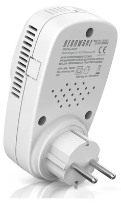 A white digital plug-in thermostat is shown from a low-angle, diagonal perspective, plugged into an electrical outlet. The back of the device, which faces the viewer, displays text and regulatory symbols.