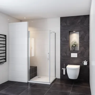 A modern bathroom with a glass shower enclosure, toilet, and a black tiled accent wall.