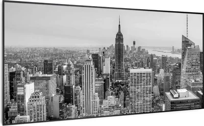 A panoramic black and white view of a city skyline, dominated by skyscrapers, including the Empire State Building.