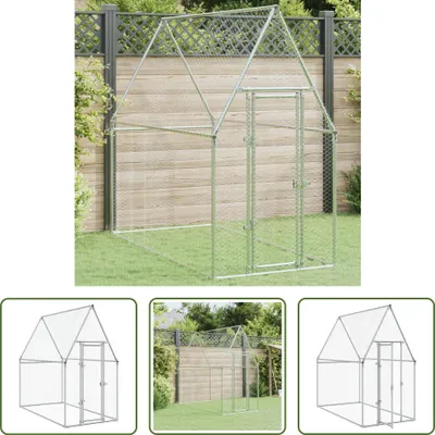 A metal chicken coop shown in a yard with a wooden fence.