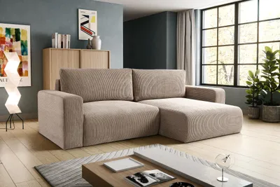 A modern living room with a sectional sofa, coffee table, and artwork.