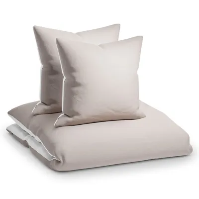 A stack of taupe and white bedding, including two pillows and a duvet cover, on a white background.