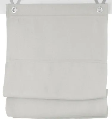 A close-up view of a light gray fabric blind with grommets at the top.