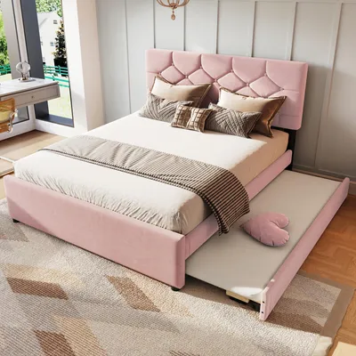 A pink upholstered bed with a pull-out trundle bed in a bedroom setting.