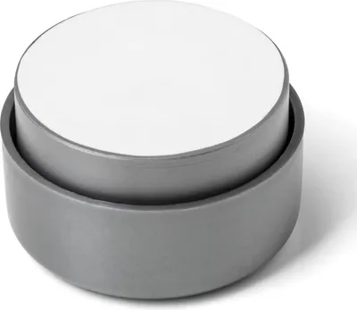 A close-up studio shot of a gray furniture foot with a white top.