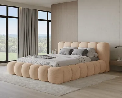 A bedroom with a large, upholstered bed and large windows overlooking a natural landscape.