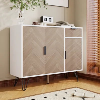 A sideboard with a herringbone pattern on the doors and a drawer, placed on a rug in a room.