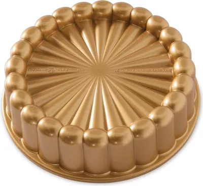 A gold-colored cake pan with a fluted design.