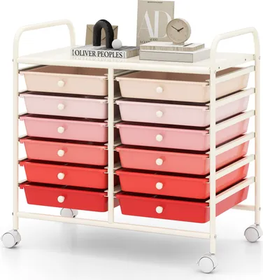 A white rolling cart with multiple drawers in varying shades of pink and red, topped with decorative items and books.
