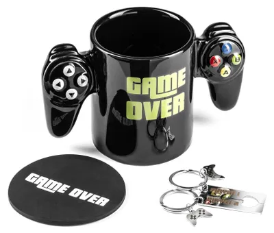A black mug with video game controller handles and the words "GAME OVER" printed on it, along with a matching coaster and keychain.