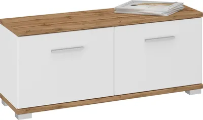 A white and wood-grain storage bench with two doors and silver handles, with a stack of magazines on top.