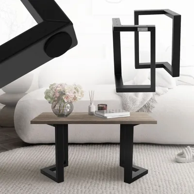A coffee table with a wood top and black metal legs, placed in a living room setting with a sofa and a rug.
