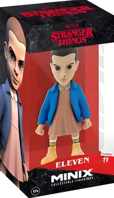A collectible figurine of Eleven from Stranger Things, displayed in its packaging.
