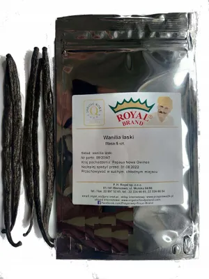 A package of vanilla beans with loose vanilla beans next to it, on a white background.