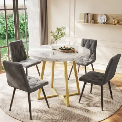 A round dining table with four chairs in a well-lit room with a large window.