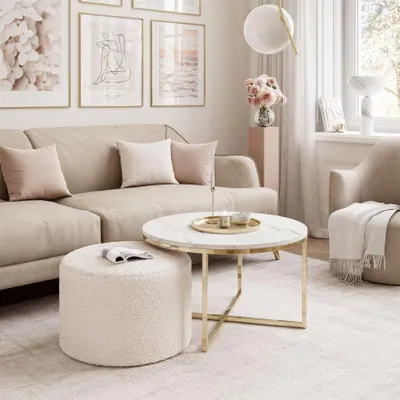 A living room scene with a couch, coffee table, and ottoman.