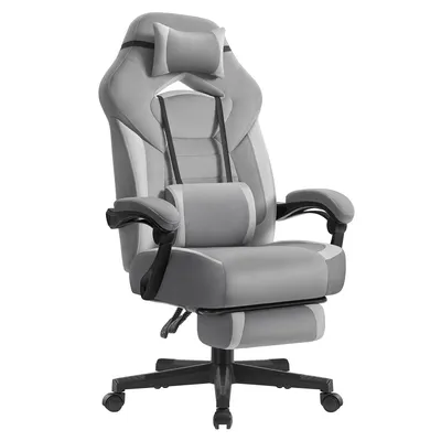 A gray and black gaming chair with a footrest, headrest, and lumbar pillow is shown against a white background.