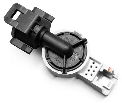A close-up studio shot of a dishwasher water level sensor switch on a white background.