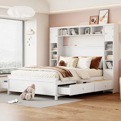 A white bed with storage drawers and a bookshelf headboard in a bedroom.