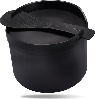 A black rice cooker with a lid and spoon resting on top, set against a white background.