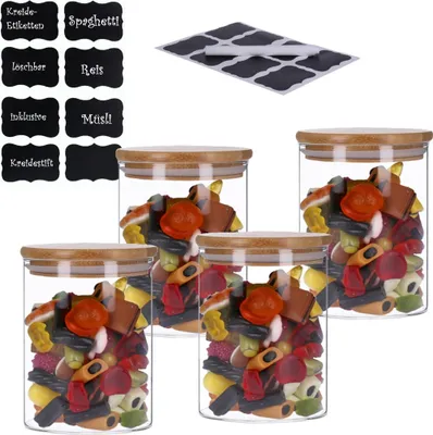 Four glass jars filled with candy, with chalk labels and a chalk pen nearby.