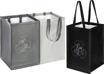 Three recycling bags are shown against a white background. Two bags are connected and side-by-side, one gray and one light gray. The third bag is black and stands alone to the right. Each bag has a recycling symbol with icons of bottles and jars.