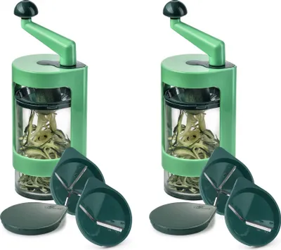 Two green spiralizers with zucchini noodles inside, along with their interchangeable blades and base plates, are displayed against a white background.