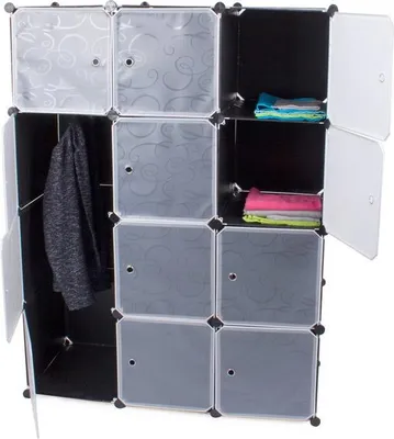A modular storage unit with multiple compartments, some open and some with doors, displaying clothing and folded items.