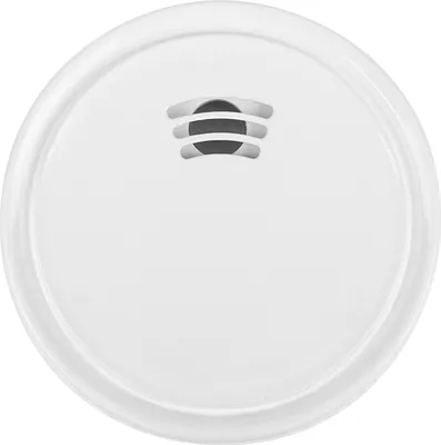 A top-down view of a white smoke detector on a white background.