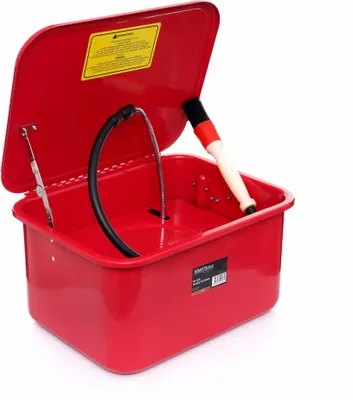 A red parts washer with its lid open, showing a brush and a hose inside.
