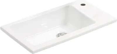 A white ceramic sink with a drain.
