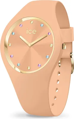 A close-up studio shot of a peach-colored watch with gold accents and colorful gem markers.